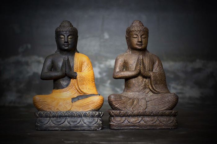 Zittende Buddha met handen in gebed